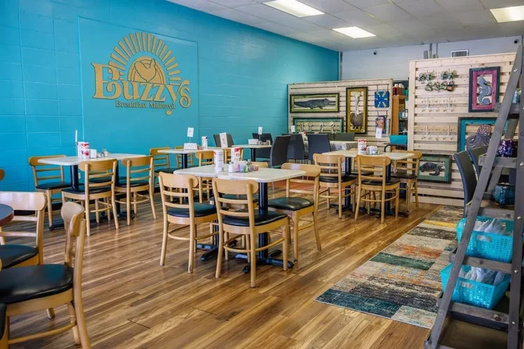 Inside Buzzy's Midtown: bright blue walls, wood floors and local art