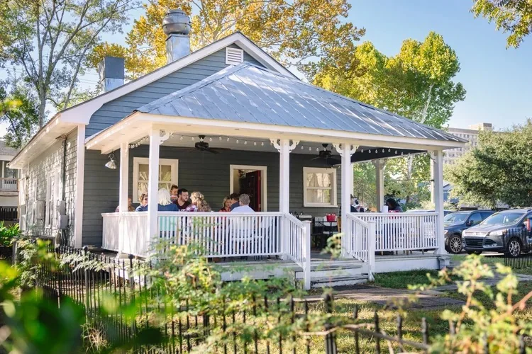 Buzzy's Downtown, a gray cottage with a white porch
